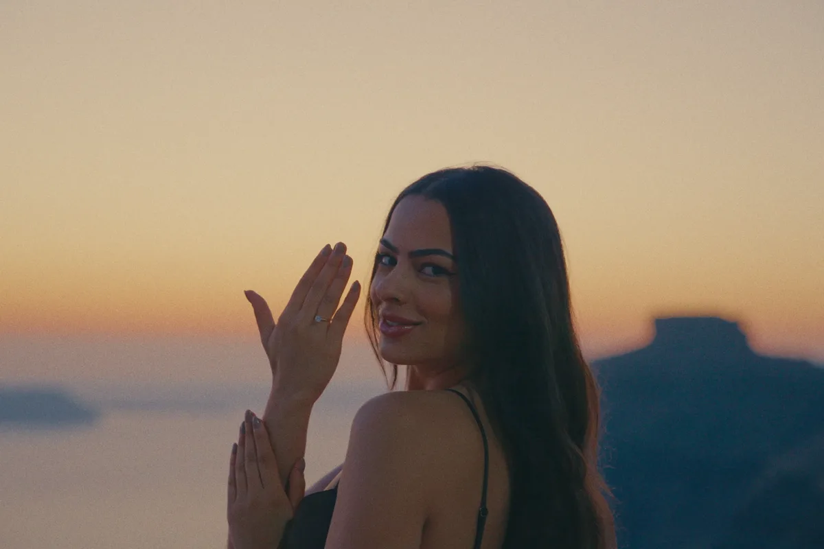 Lilian showing the ring against the sunset